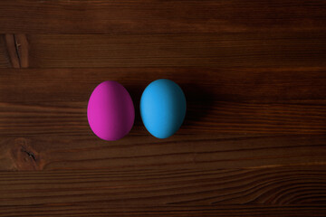 Colorful eggs for Easter on a wooden table. View from above.