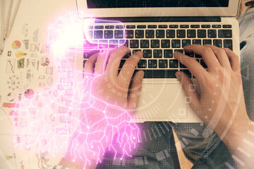 Double exposure of man's hands typing over computer keyboard and virtual reality hologram drawing. Top view. Technology concept. Future.