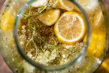 homemade syrup of elderberry flowers in a glass jar