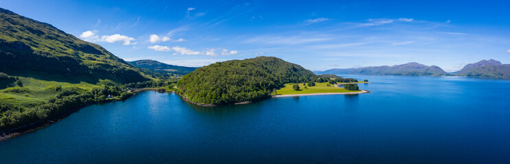 Obraz na płótnie Canvas aerial image of loch linnhe on the west coast of the argyll and lochaber region of scotland near kentallen and duror showing calm blue waters and clear skies with green forest coast line