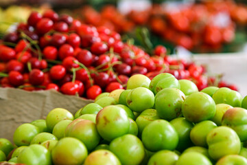 Green cherry plums and red berries