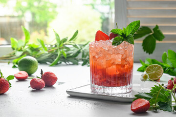Freshness cocktail with strawberries puree, soda, lemonade, ice cube and lime. Homemade beverage.
