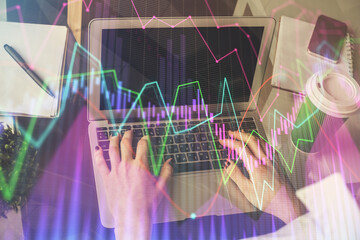 Double exposure of woman hands typing on computer and forex chart hologram drawing. Stock market invest concept.