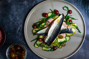 Grilled mackerel with gooseberry ketchup, pickled cucumber and whole gooseberries and samphire