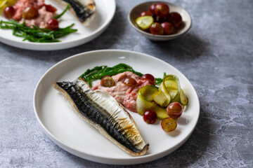 Grilled mackerel with gooseberry ketchup, pickled cucumber and whole gooseberries and samphire