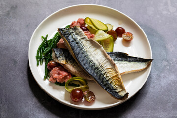 Grilled mackerel with gooseberry ketchup, pickled cucumber and whole gooseberries and samphire