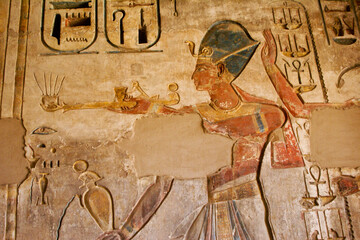 Painted reliefs inside room at Medinat Habu Temple, Luxor, Egypt