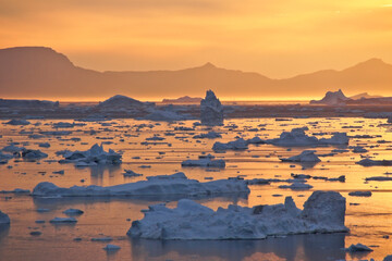 Midnight Sun and icebergs in Disko Bay, Ilulissat, West Greenland