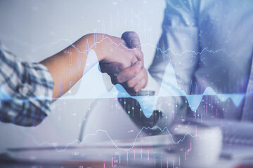 Double exposure of forex graph hologram and handshake of two men. Stock market concept.