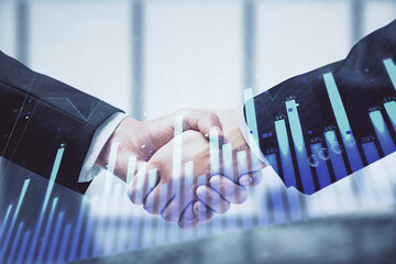 Double exposure of forex graph hologram and handshake of two men. Stock market concept.