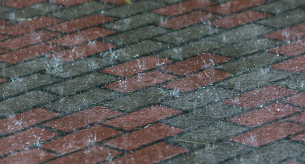 Wet granite stone tiles on a city street during the rain