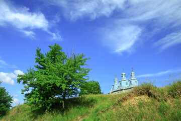 Church on a hill on the outskirts of the village. Christian temple landscape in Russia. Stock photo background
