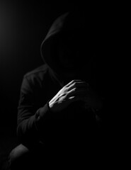 Obraz premium Low key photography, crossed hands of a raper 