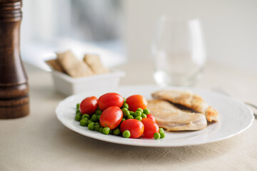 chicken filet with cherry tomatoes and peas