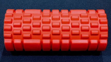 Close-up view of a foam roller on a yoga mat