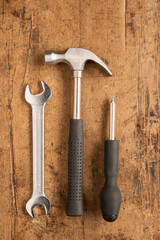 Hammer, cutting plier, screwdriver and a wrench key