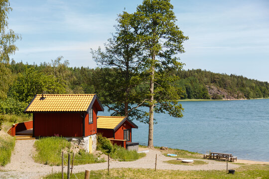 Red summer garden cottage in Sweeden. Traditional Sweden wooden old house. Life on the one of Sweeden islands