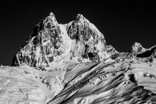 Black and white photo of double summit Ushba peak. Is notable mountain of the Caucasus Mountains located in the Svaneti region of Georgia, known as the "Matterhorn of the Caucasus"
