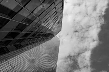 Black and white tone, Low angle view of mixture material exterior facade and wall of glass modern office buildings. Abstract Architectural Geometry with horizontal line of Urban metropolis.