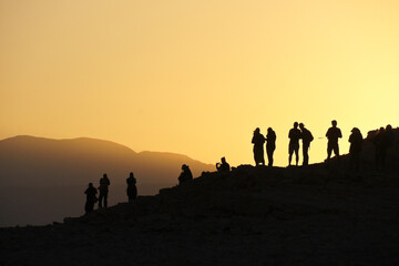 Silhouette of people viewing sunset from Mirador Coyote, above Valle de la Luna (Moon Valley), Atacama Desert, Norte Grande, Chile