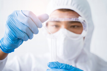 Medical healthcare biology scientist close up examination dropping chemical in glass tubes testing...