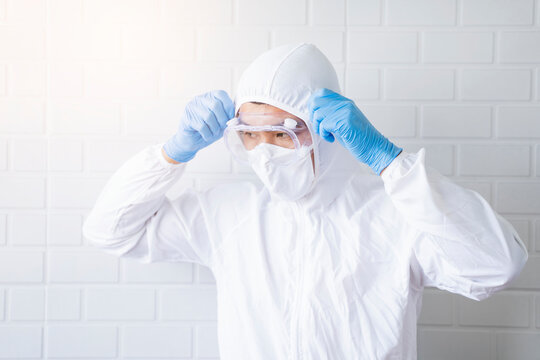 Medical healthcare scientist doctor wearing goggles blue latex gloves lab suit protective overall protection from bacterial infection virus safety clean sanitize, hospital laboratory white background