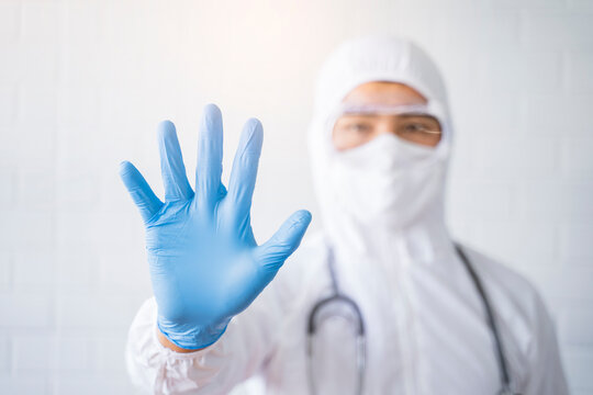 Medical healthcare scientist doctor making hand gesture warning stop sign wearing goggles blue latex gloves white lab suit stethoscope protective bacterial infection coronavirus, hospital laboratory