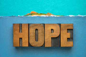 hope word - word abstract in vintage letterpress wood type against abstract paper landscape of a...