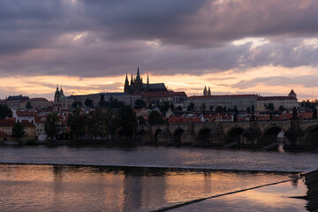 Charles Bridge, Prague Castle, St. Vitus Cathedral and the flowing Vltava River and the roofs of...