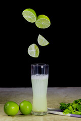 fresh fruit juice levitating in drop to glass