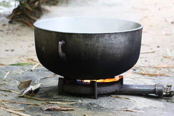 Massive street food cooking pot on single burner fire. 