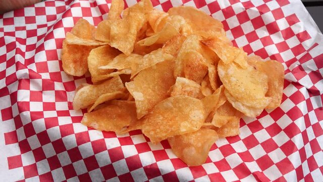delicious chips on a plate with white and red square design, fast food, close up