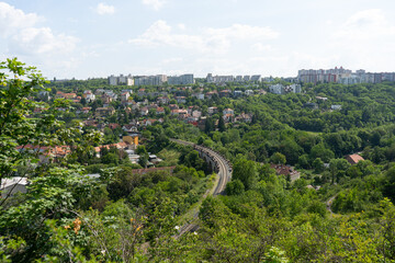 
view of the Czech countryside near Prague and buildings in the background and tracks and a viaduct for trains