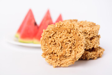 Local Thai snack, Deep fried sweet crispy rice mixed with watermelon juice and cane sugar drizzle (Khao Tan Nam Tangmo)