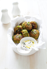 Roasted chickpeas falafel patties in white cooking tray close up