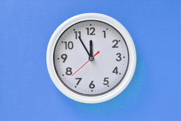 White clock on a blue background