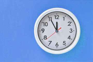 White clock on a blue background