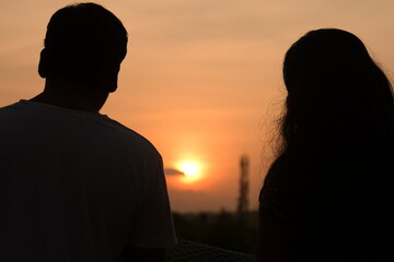 silhouette of man and woman in sunset