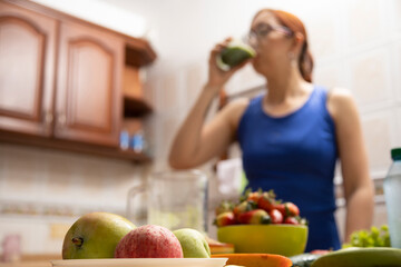 girl drinking a fruit and vegetable shake, food in the foreground selective approach