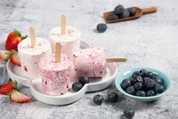 Healthy summer desserts. Ice cream popsicles On white marble table