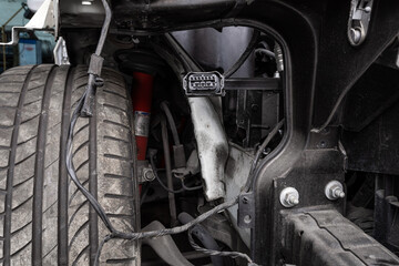 View of a disassembled , suspension swamp buggy. Close-up of a car hub, brake caliper, brake pads, brake disc, wheel bearing prepared for repair.