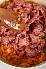 Adding ground meat into frying pan. Making Lasagna Bolognese Series.