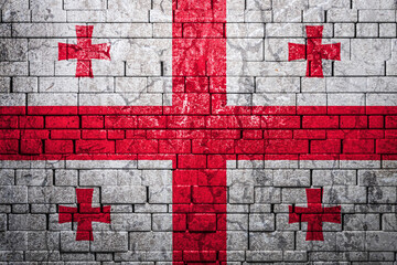 National flag of Georgia on brick  wall background.The concept of national pride and symbol of the...
