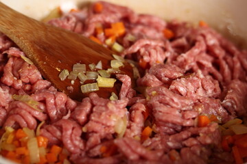 Adding ground meat into frying pan. Making Lasagna Bolognese Series.