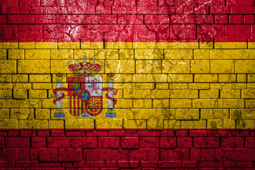 National flag of Spain on brick  wall background.The concept of national pride and symbol of the country. Flag  banner on  stone texture background.