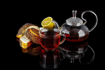 black tea with lemon on a black background hot