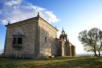 Fototapeta na wymiar Isolated medieval Spanish Chapel with tree on the side in the north of Spain.