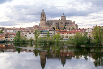 Fototapeta na wymiar Salamanca city view from the bridge with reflection from the river. 