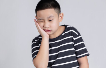 Asian boys has a toothache. Oral Care Concepts