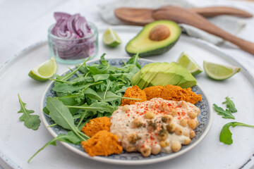 Vegan lunch bowl with quinoa, hummus, chickpeas, avocado
